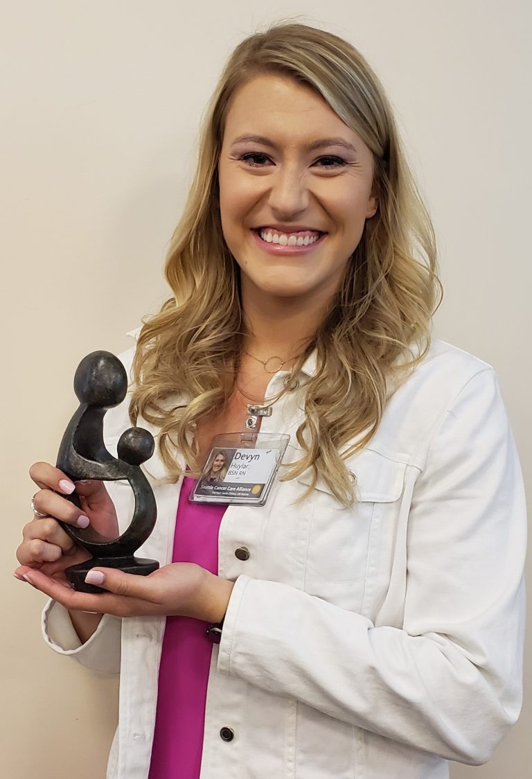 Fred Hutch Nurse Devyn Huylar with the DAISY Award, which recognizes the outstanding care of nurses nationwide.